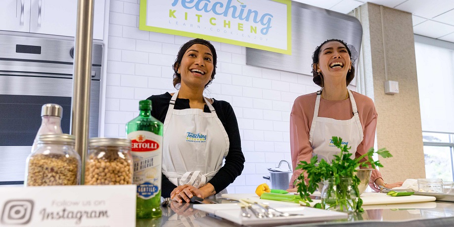 two nutrition students laughing and smiling in kitchen